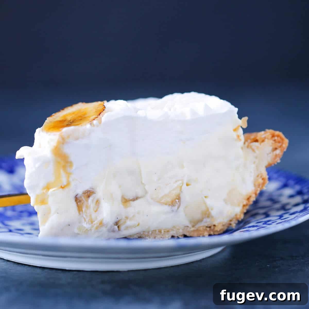 Creamy Banana Cream Pie Slice A slice of Banana Cream Pie on a small blue plate, highlighting the creamy texture.
