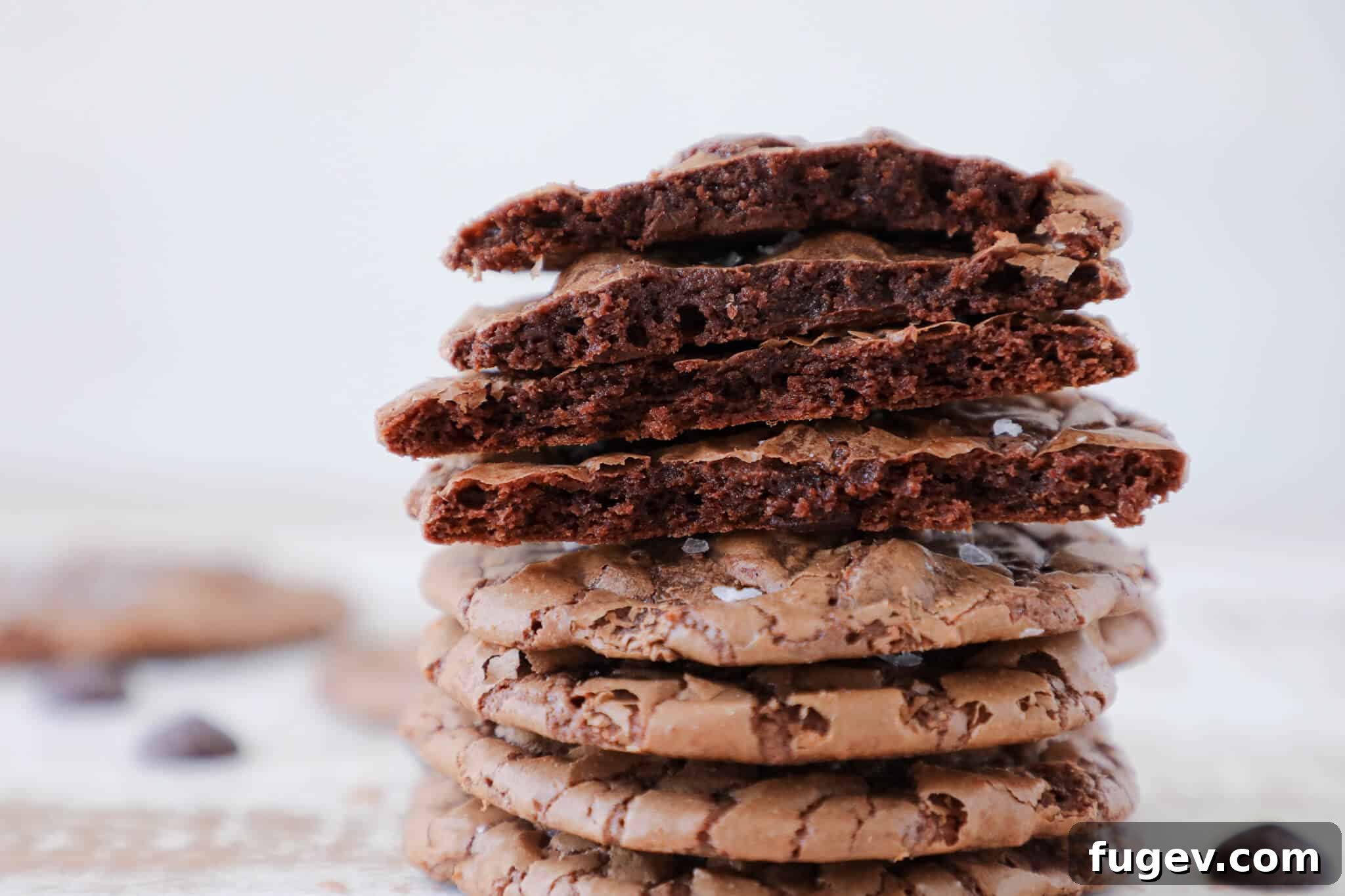 Fudgy Brownie Cookies 4 Brownie cookies in a stack with some cracked open.