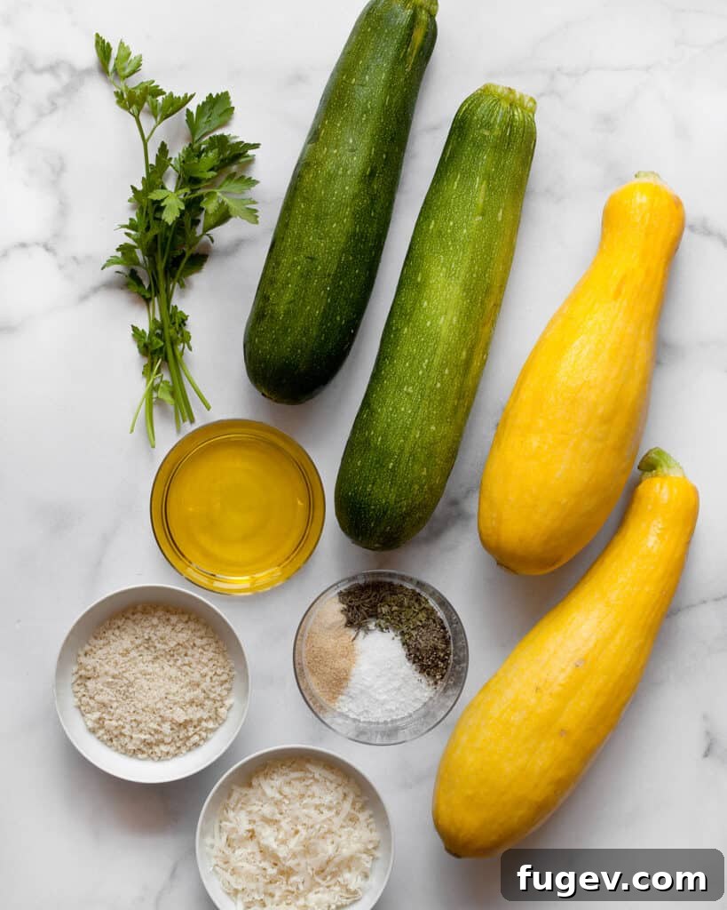 Golden Roasted Zucchini and Squash 3 All ingredients laid out: diced zucchini, yellow squash, panko breadcrumbs, grated Parmesan cheese, olive oil, and a selection of dried Italian herbs and spices.