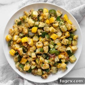 Golden Roasted Zucchini and Squash 9 Roasted zucchini and squash on a plate with fresh herbs.