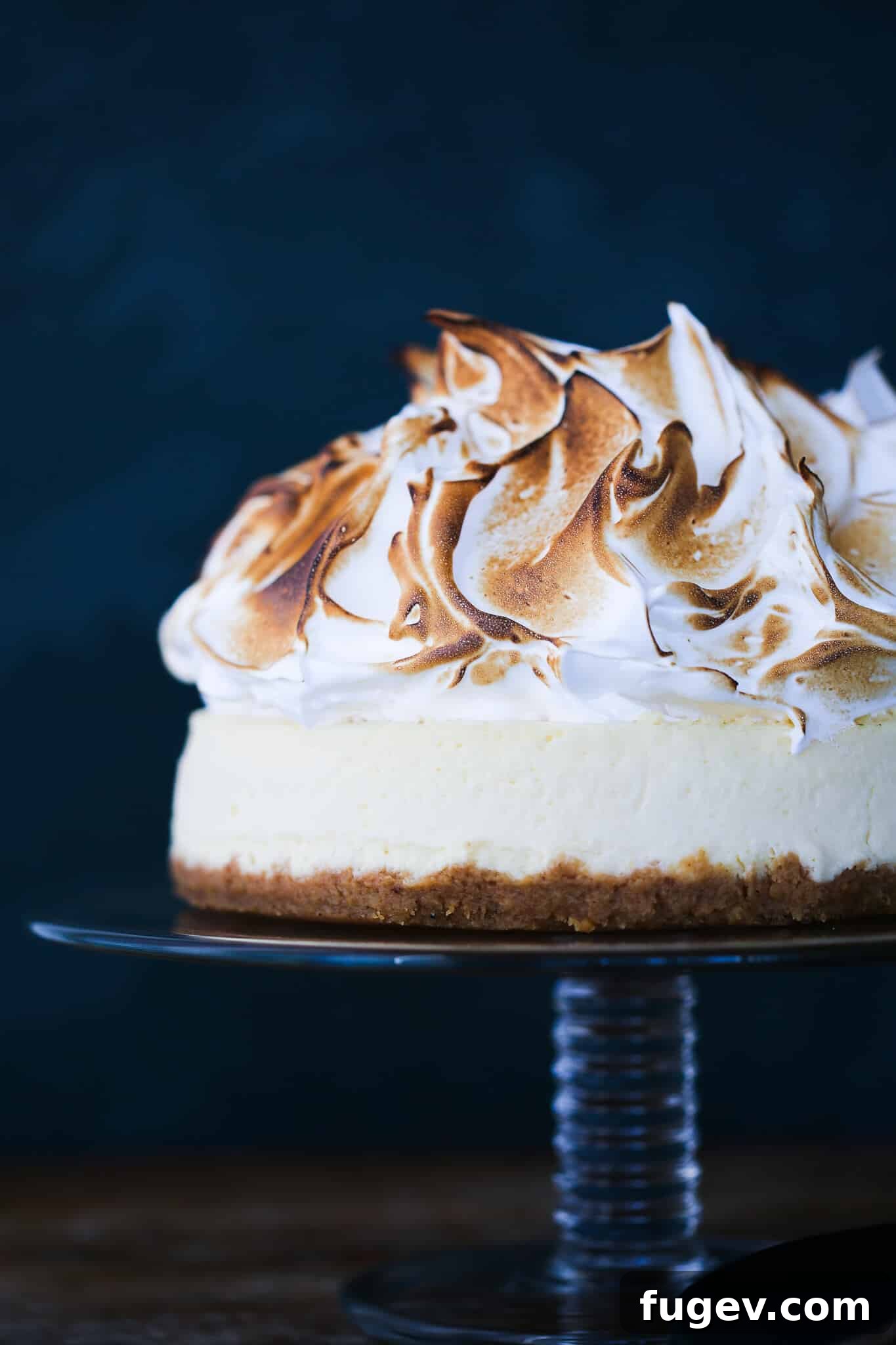 Zesty Lemon Cloud Cheesecake 2 Lemon Meringue Cheesecake slice with towering meringue, perfect for a special occasion.