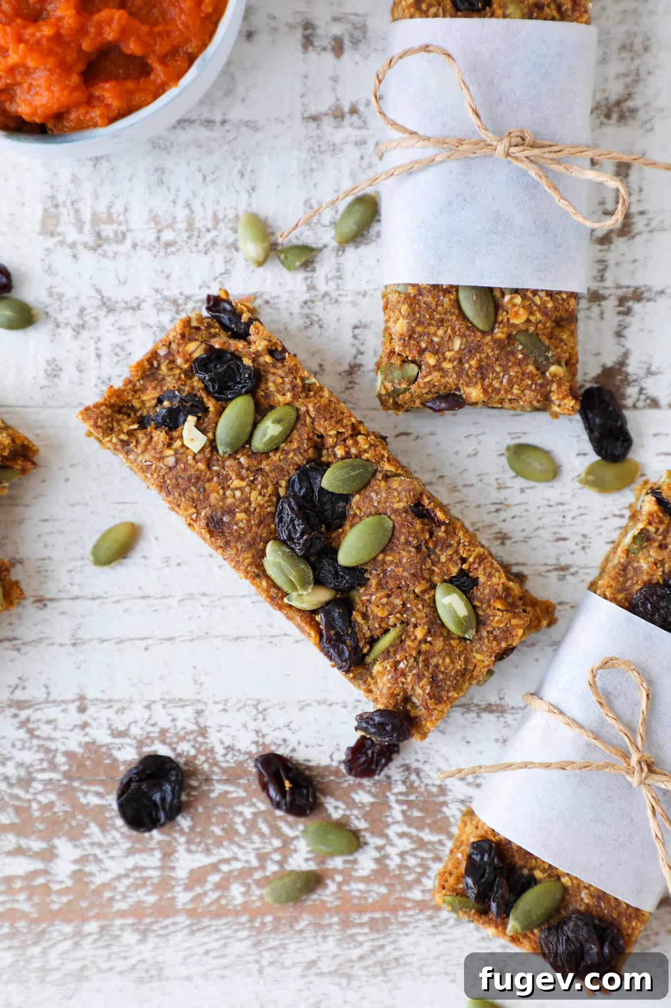 Irresistible Gluten-Free Pumpkin Squares 4 Gluten-Free Pumpkin Spice Energy Bars with pumpkin seeds on top.