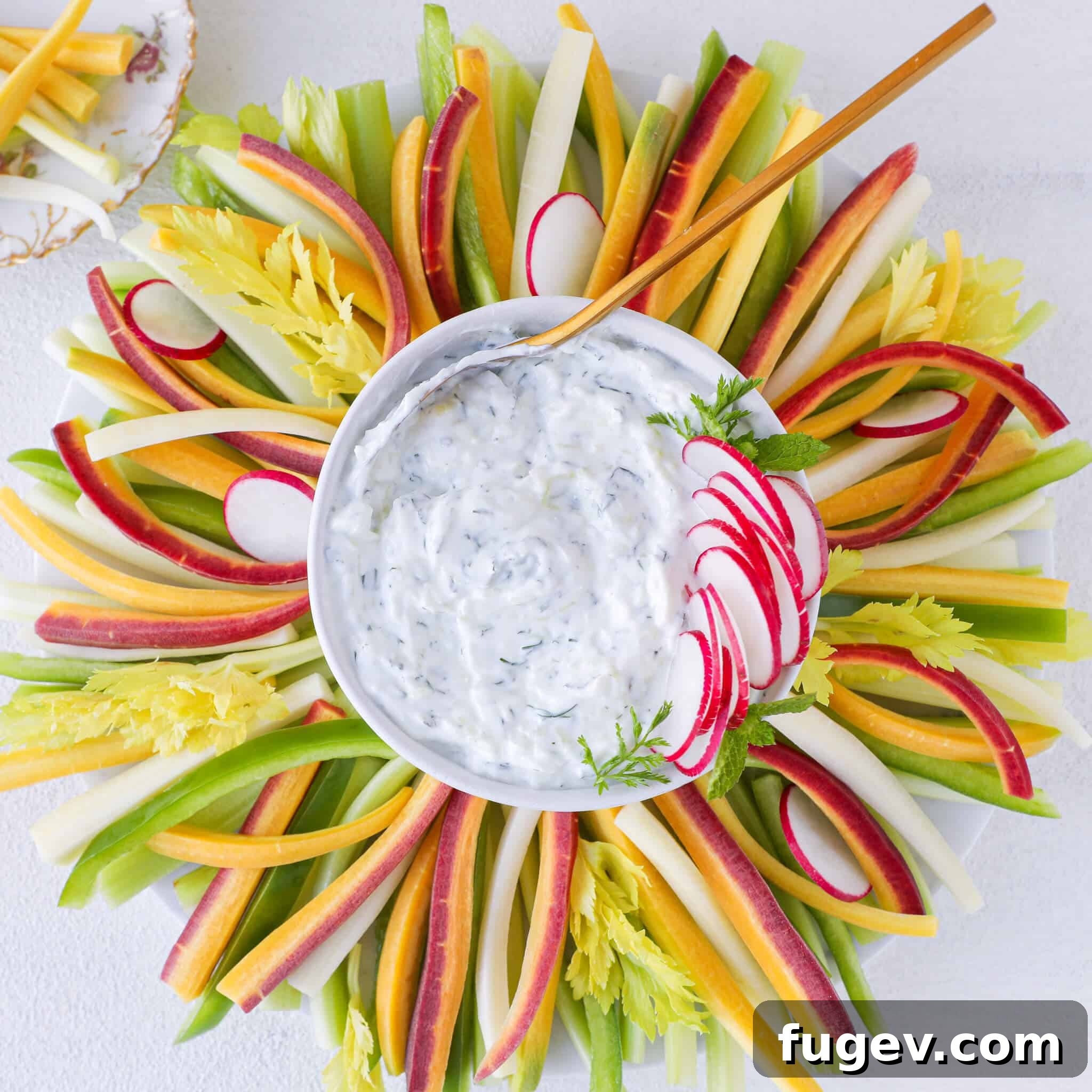 Refreshing Greek Tzatziki 3 Tzatziki Dip served elegantly with a gleaming gold spoon, inviting you to taste its creamy freshness.