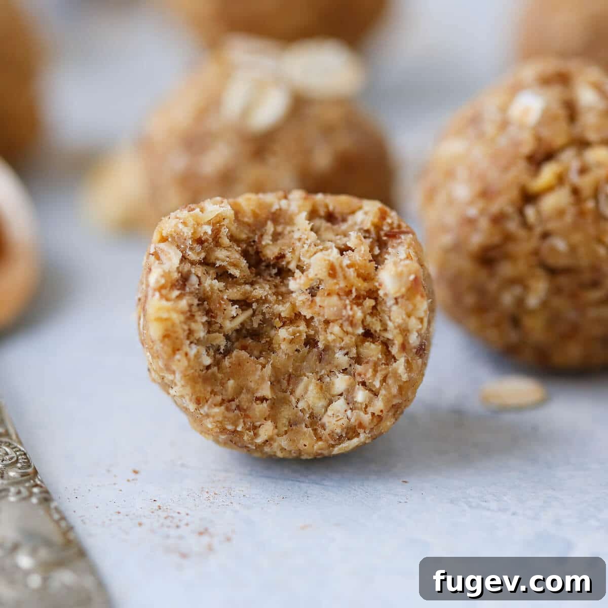Apple Crisp Power Bites 4 A bitten Apple Crisp Energy Bite revealing its soft, chewy interior