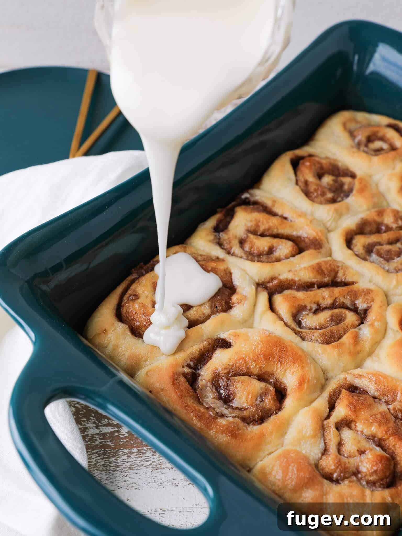 Irresistible Cinnamon Rolls with Tangy Cream Cheese Glaze 2 The Best Cinnamon Rolls glazing the baking dish