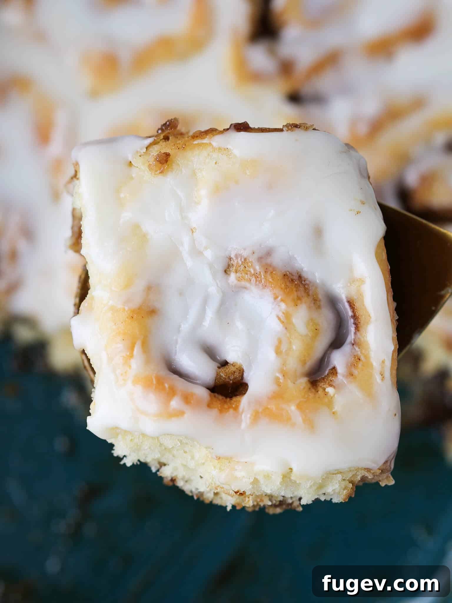 Irresistible Cinnamon Rolls with Tangy Cream Cheese Glaze 5 The Best Cinnamon Rolls top view roll on gold server