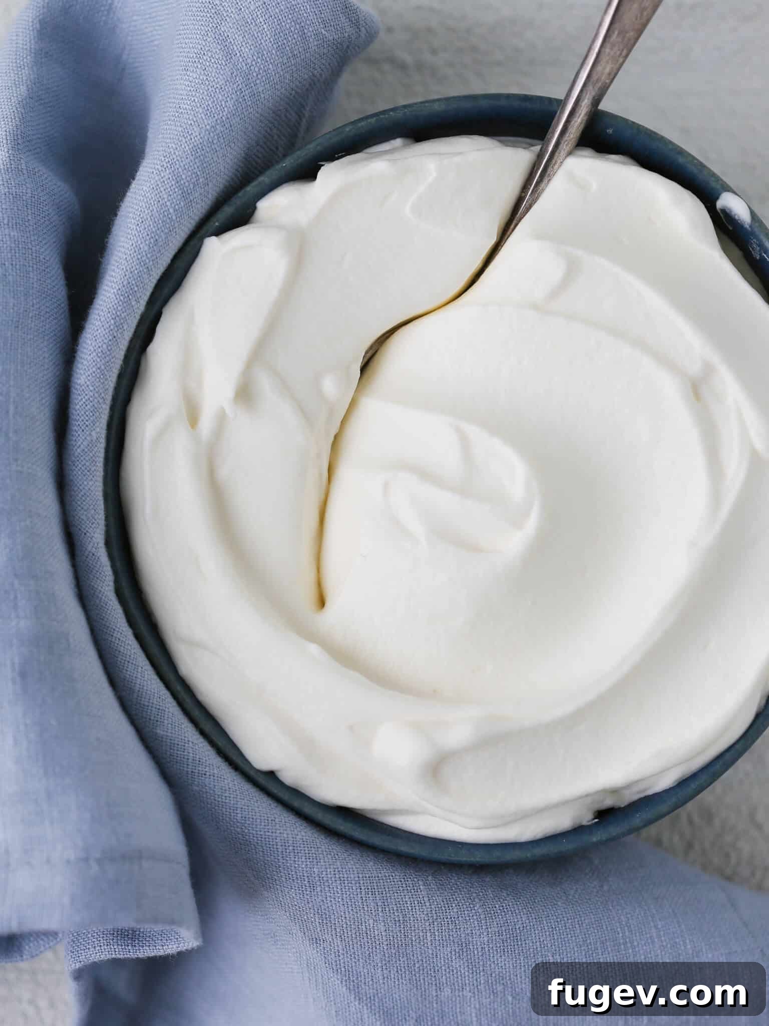 Fluffy Homemade Delight 2 Rich homemade whipped cream swirled beautifully on a blue napkin, ready to be served