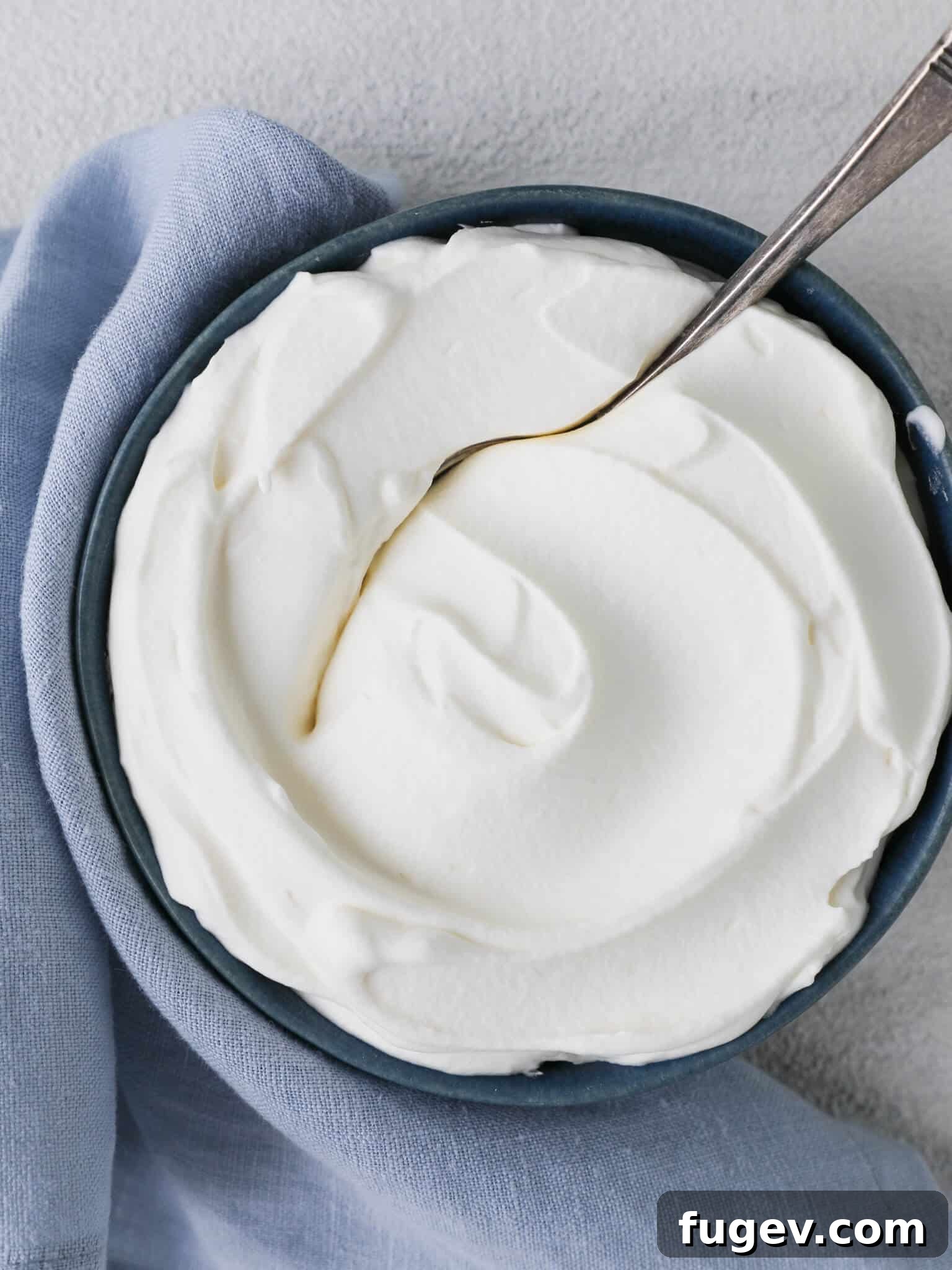Fluffy Homemade Delight 6 Homemade whipped cream served elegantly in a vintage spoon, ready for tasting
