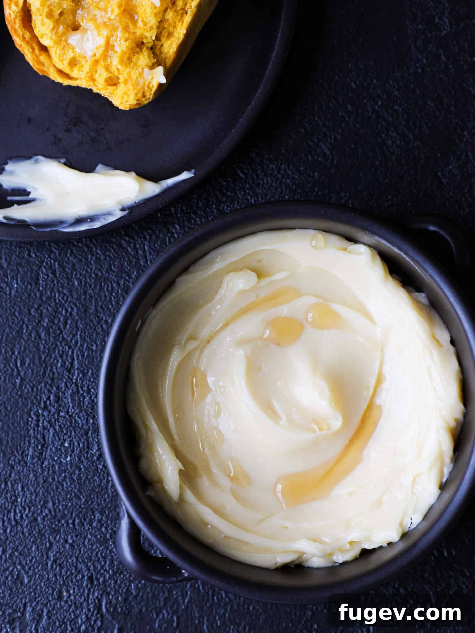 Velvety Maple Butter 5 Maple butter drizzled with maple syrup, emphasizing its key ingredient.
