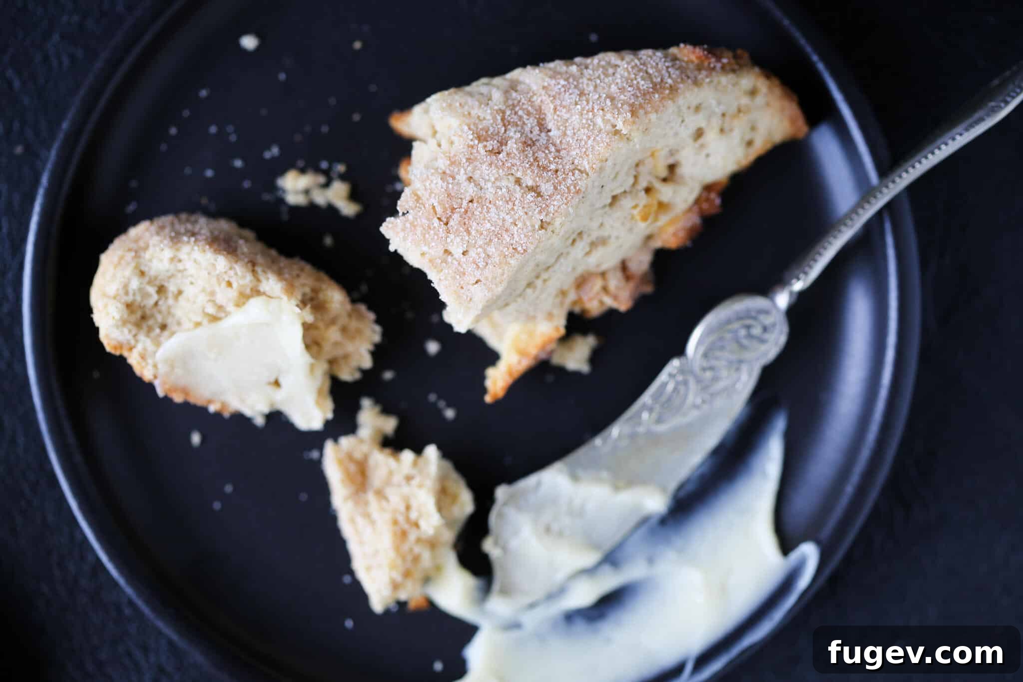 Harvest Apple Spice Scones 3 Spiced Apple Scones artfully arranged on a black plate, highlighting their perfectly baked texture