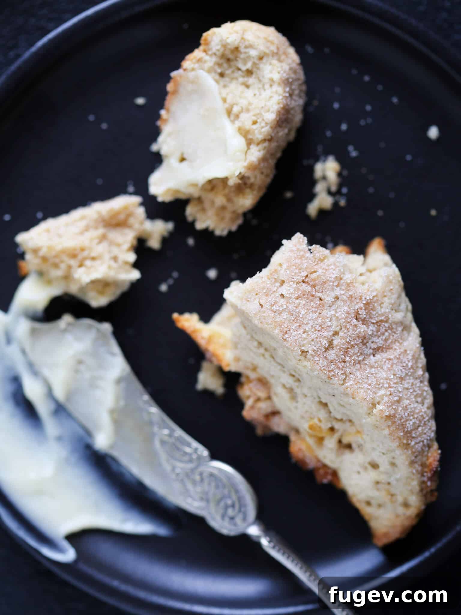 Harvest Apple Spice Scones 5 A Spiced Apple Scone sliced in half, revealing its tender, moist interior, served with a silver knife