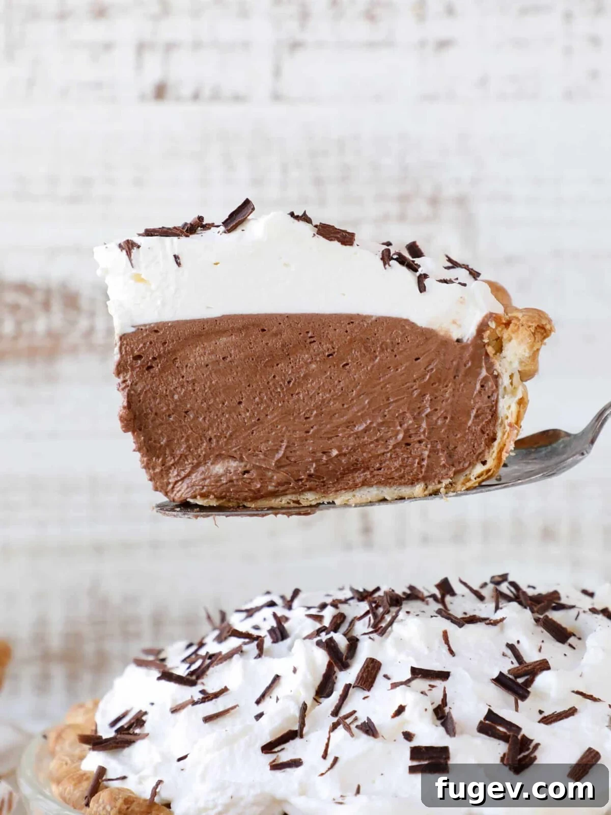 Decadent Chocolate Silk Pie 2 A slice of French Silk Pie served on a plate with a pie server.
