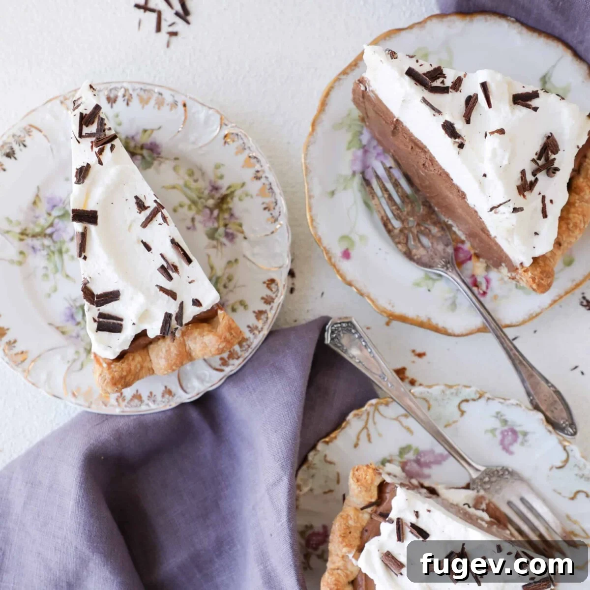Decadent Chocolate Silk Pie 3 Three slices of French Silk Pie on white plates with a white background.