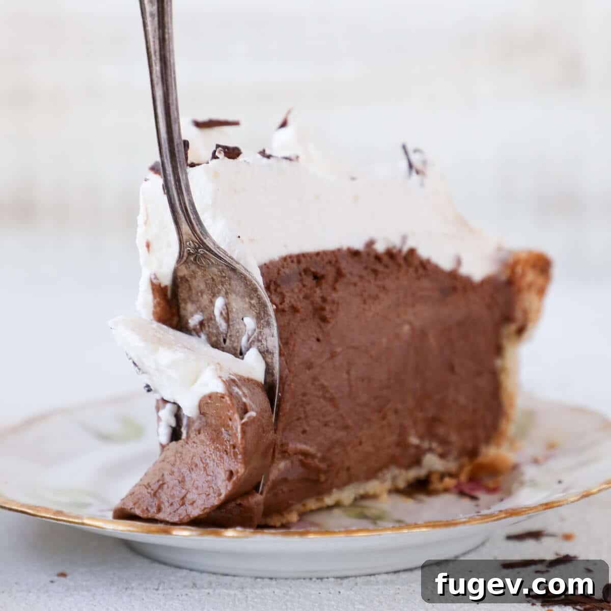 Decadent Chocolate Silk Pie 5 A slice of French Silk Pie on a plate with a silver fork ready to enjoy.