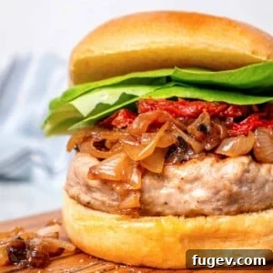 Juicy Homemade Turkey Burgers 13 Juicy turkey burger with caramelized onions and a soft bun, garnished with lettuce.