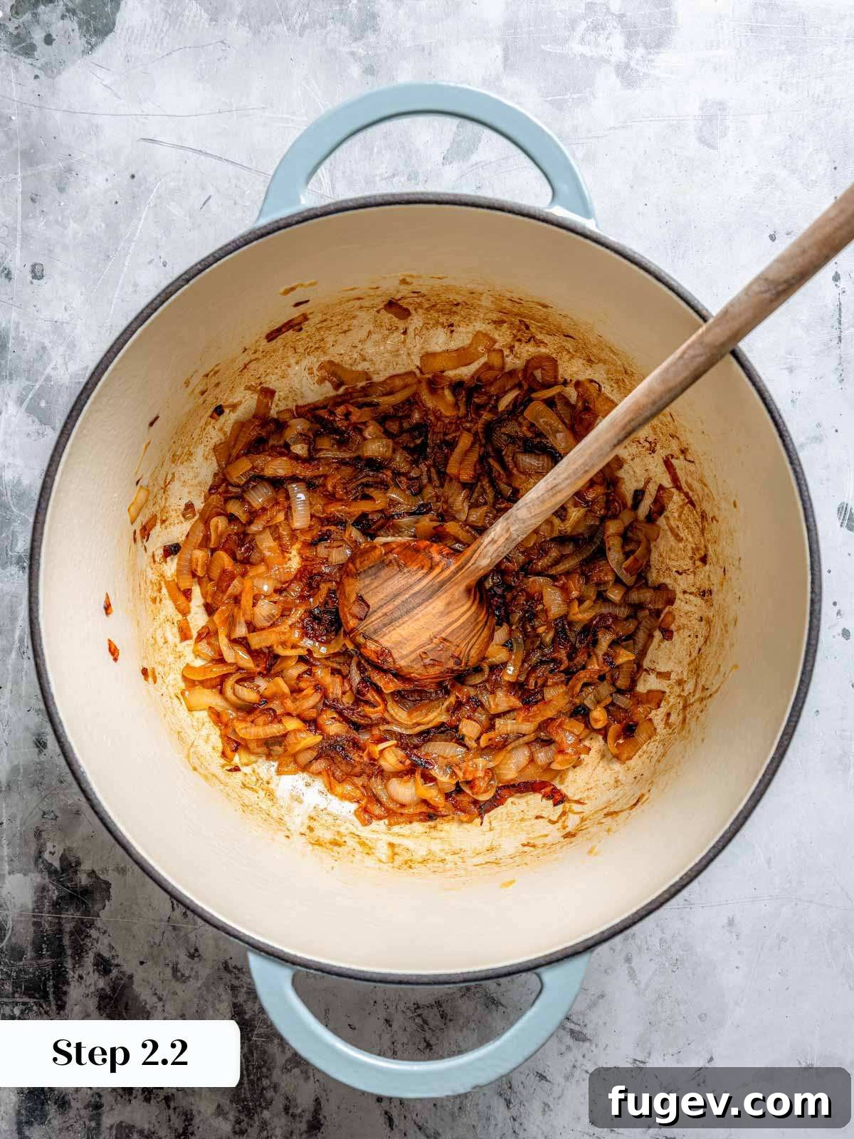 Juicy Homemade Turkey Burgers 7 Deeply caramelized onions in a Dutch oven, rich golden-brown and fragrant, with a wooden spoon resting inside.