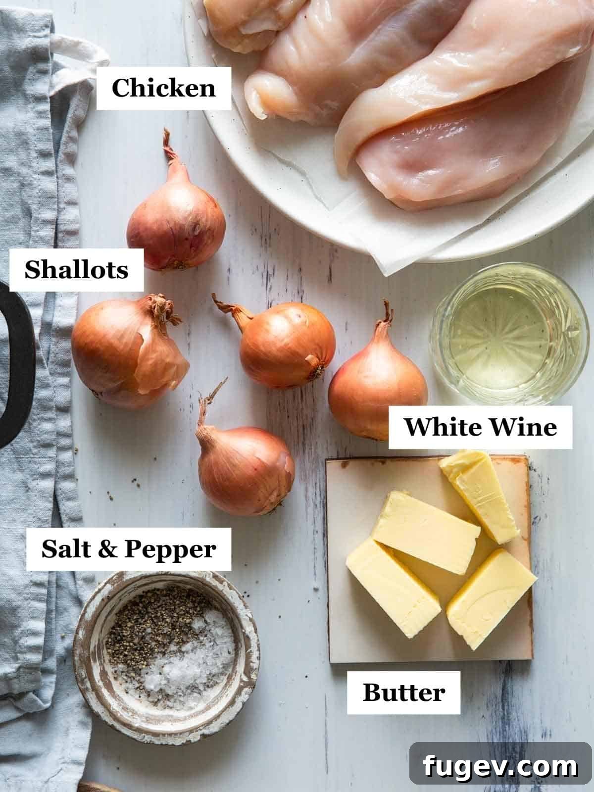 Golden Shallot Chicken 4 All the fresh ingredients for chicken with shallots, neatly arranged on a light background, including chicken breasts, shallots, butter, wine, and seasonings.