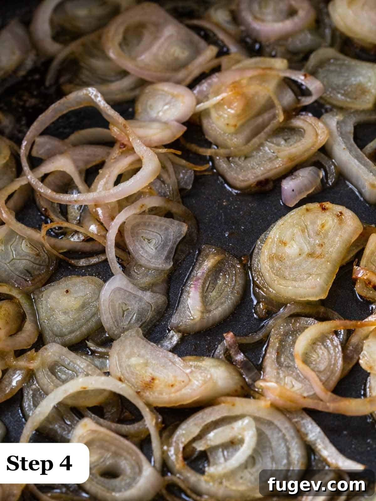 Golden Shallot Chicken 5 Step 4 of the process, showing shallots in a cast iron pan being cooked, turning golden and translucent.