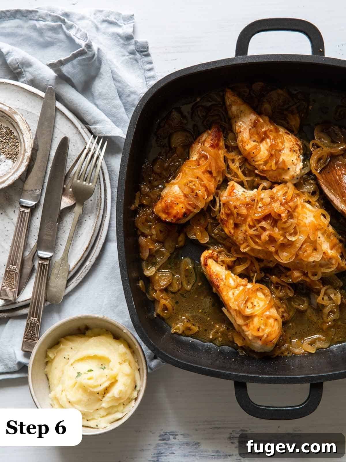 Golden Shallot Chicken 7 Step 6 of the process, a cast iron pan with chicken and shallots covered and baking in the oven.