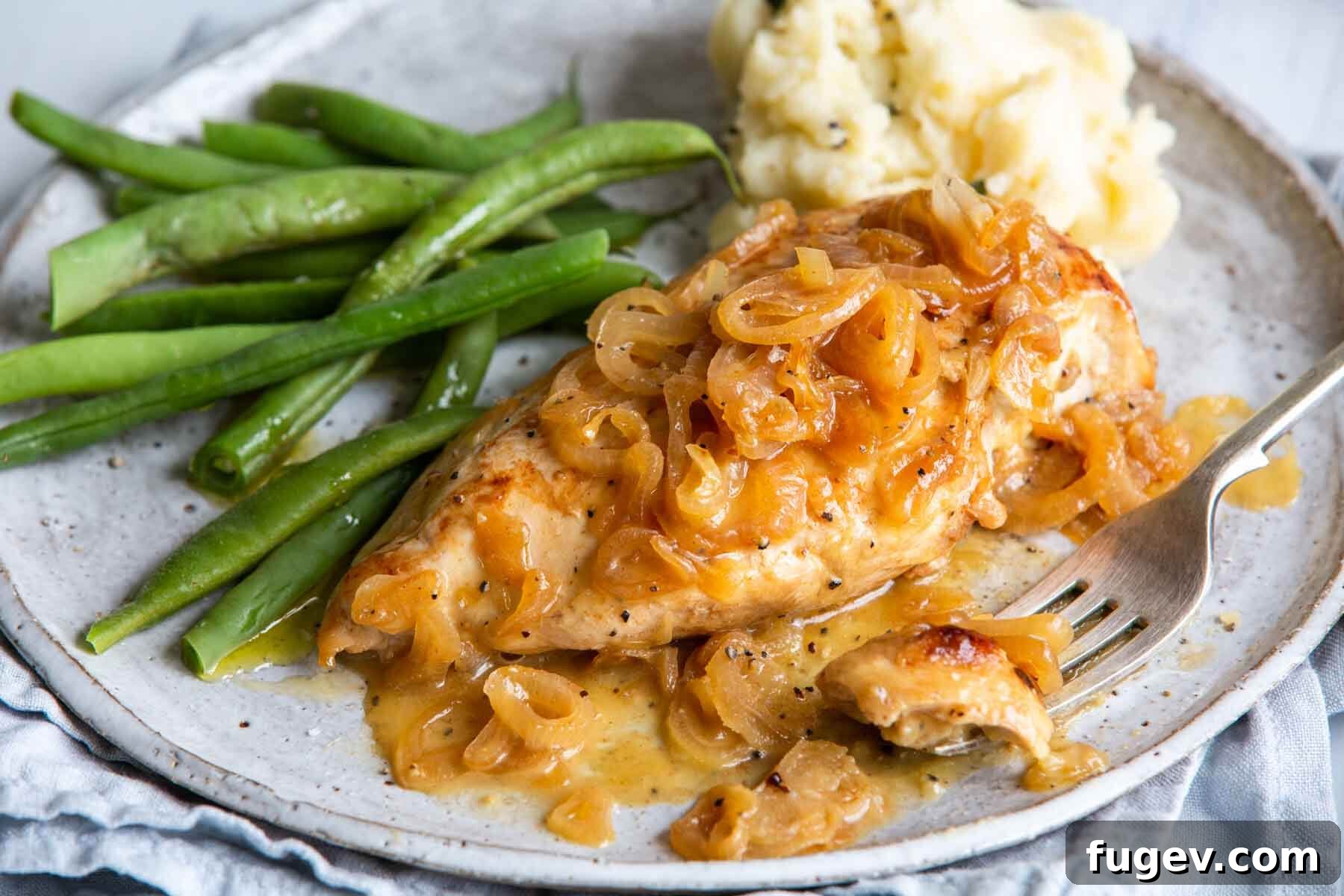 Golden Shallot Chicken 8 A generous serving of chicken with shallots on a beige plate, showcasing the rich sauce and tender chicken.