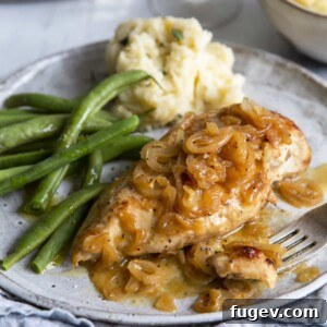 Baked Chicken and Shallots on plate with green beans and mashed potatoes