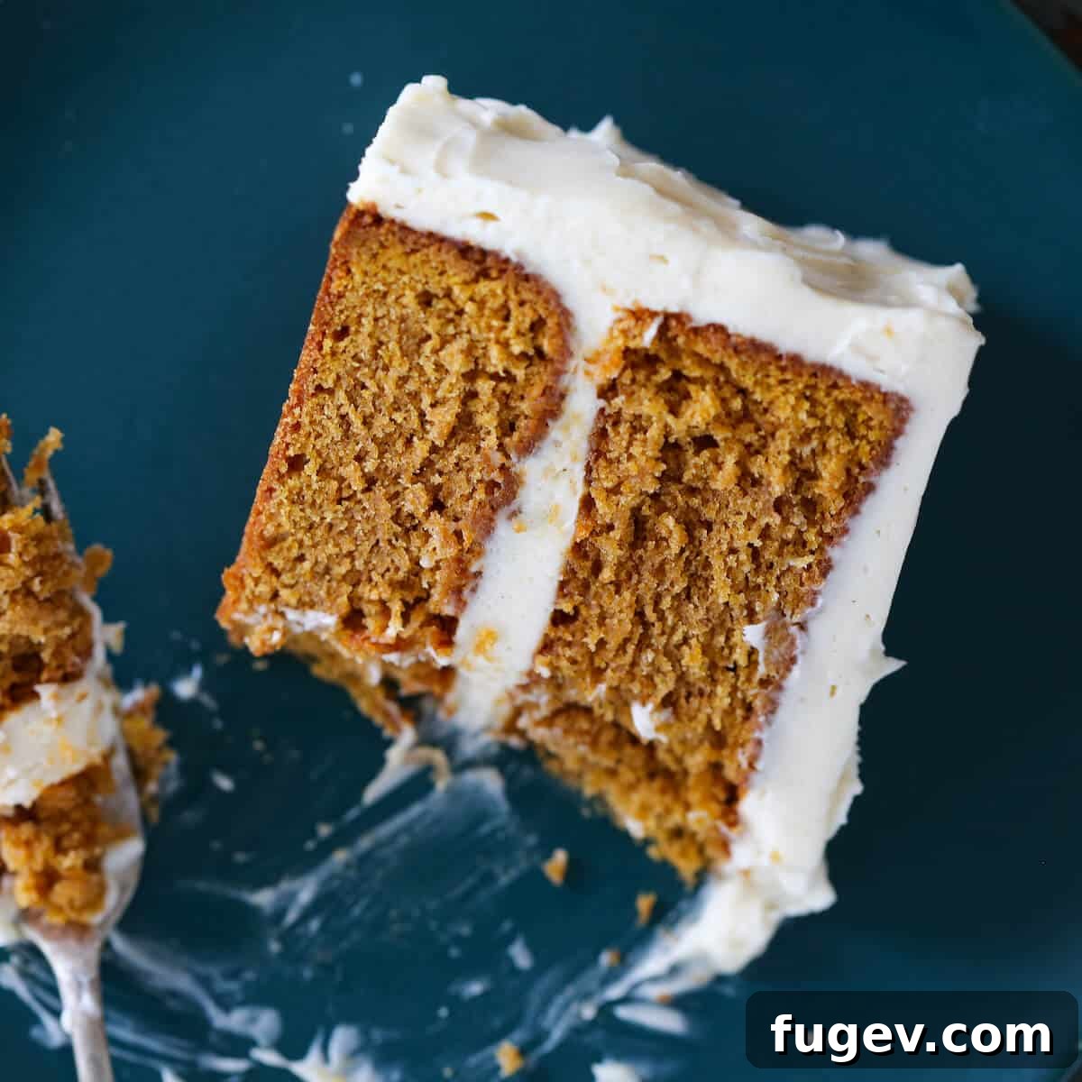 25 Irresistible Pumpkin Recipes for Fall 23 Pumpkin Spice Layer Cake slice, with a bite taken on a fork