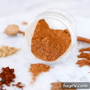 Pumpkin Pie Spice Mix spilling from jar, showcasing rich color