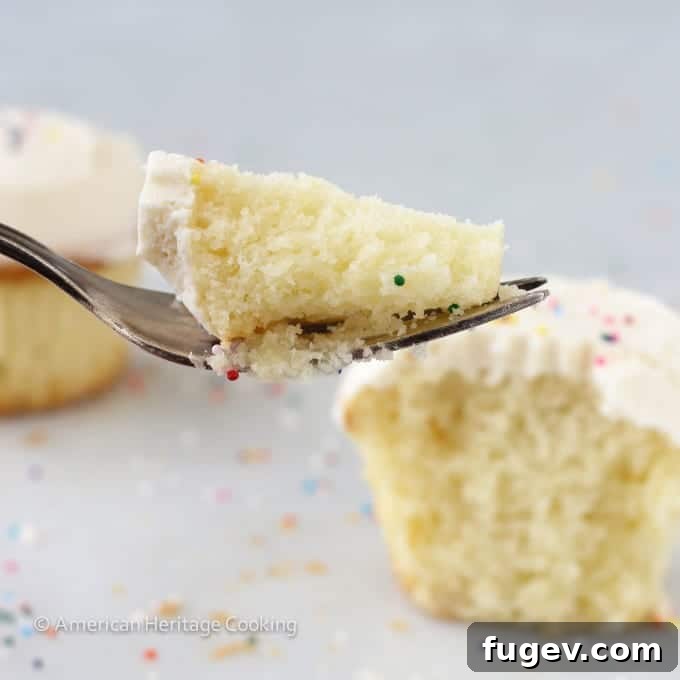 Sprinkles-Inspired Vanilla Cupcakes 6 Sprinkles Copycat Vanilla Cupcakes Side closeup with fork