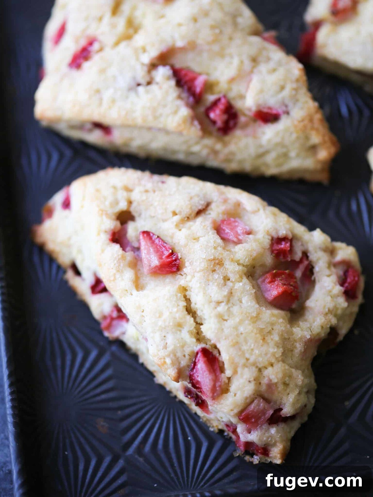 Sweet Summer Strawberry Scones 13 Strawberry Lemon Scones on a starburst patterned baking sheet, showcasing their golden crust.