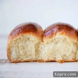 35 Essential Thanksgiving Sides 7 Two soft and fluffy Easy Dinner Rolls, showing their inviting interior texture.