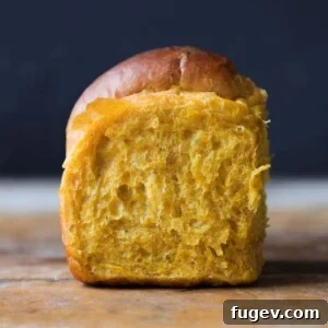 35 Essential Thanksgiving Sides 8 A perfectly baked Pumpkin Spice Dinner Roll, showing its appealing golden hue.