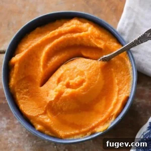 35 Essential Thanksgiving Sides 15 Silky smooth Maple Mashed Sweet Potatoes in a charming blue bowl.