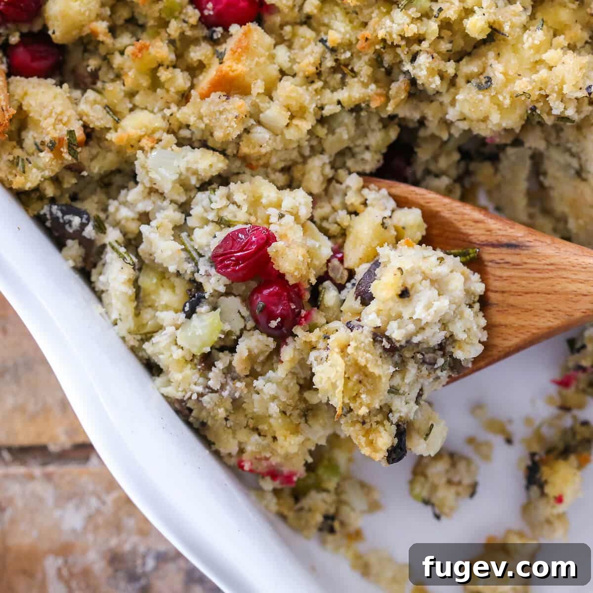 35 Essential Thanksgiving Sides 23 Mushroom Cornbread Stuffing baked in a white baking dish, rich and golden.