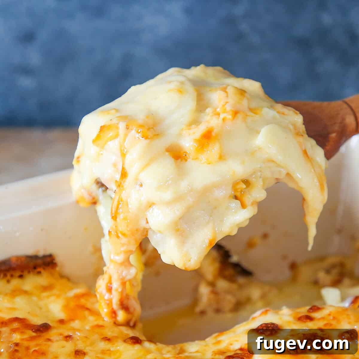 35 Essential Thanksgiving Sides 27 Rich Scalloped Potatoes served on an elegant wooden server, ready for a special occasion.