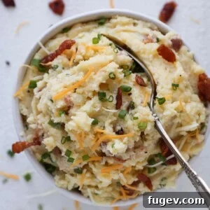 35 Essential Thanksgiving Sides 29 A delicious spoonful of Loaded Mashed Potatoes, rich with toppings.