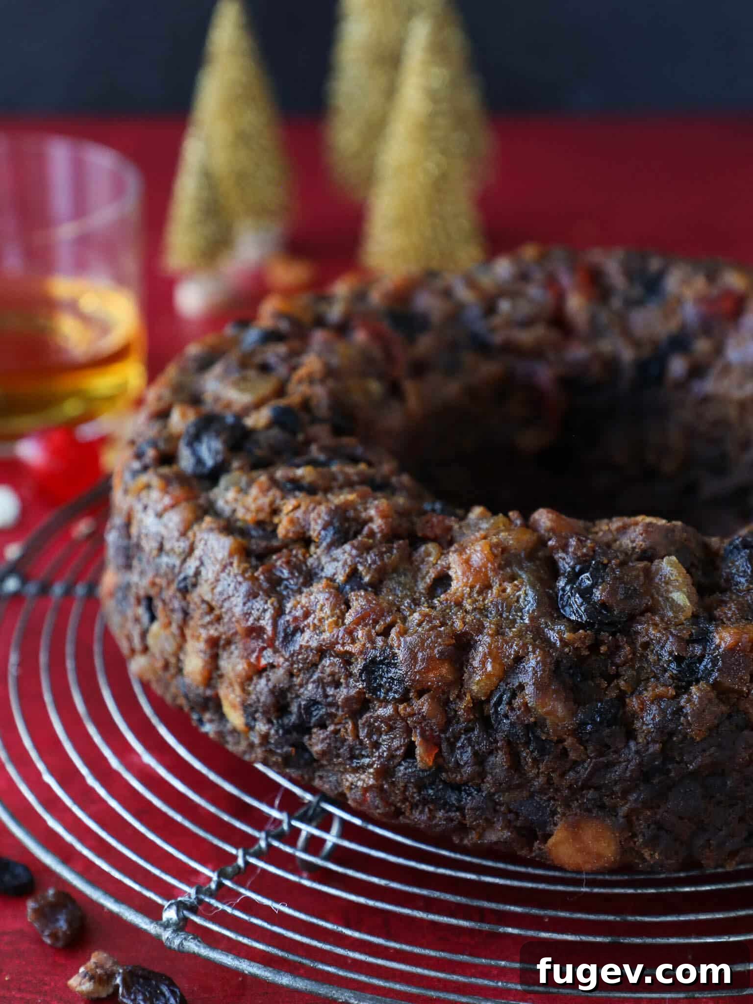 Heritage Fruitcake 5 Old Fashioned Fruit Cake slice next to a brandy glass, highlighting its rich, celebratory nature