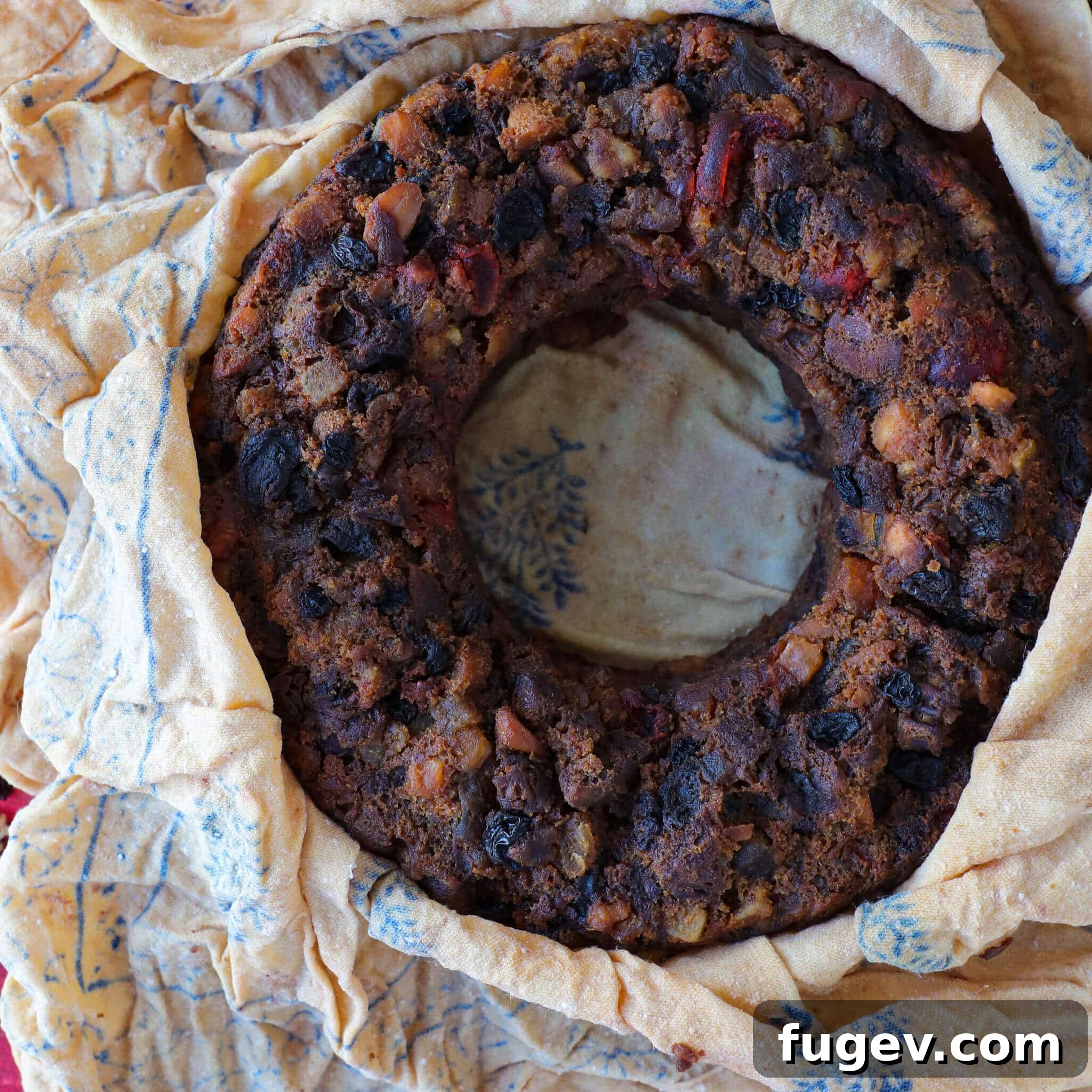 Heritage Fruitcake 10 A whole Old Fashioned Fruit Cake, elegantly presented on a serving platter, ready for slicing