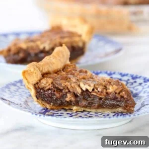 A close-up view of a Bourbon Pecan Pie with a perfectly golden brown crust, ready to be sliced and served.