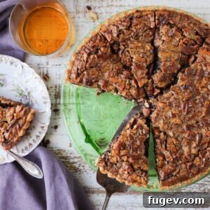 A stunning Bourbon Chocolate Pecan Tart displayed as part of an elegant tablescape, promising a luxurious dessert experience.