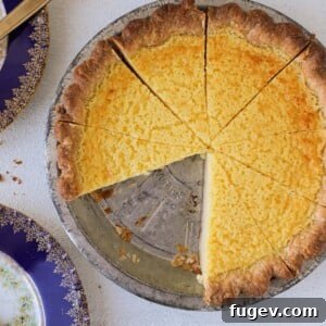 A perfectly sliced Buttermilk Pie, showcasing its smooth, creamy filling and golden crust.