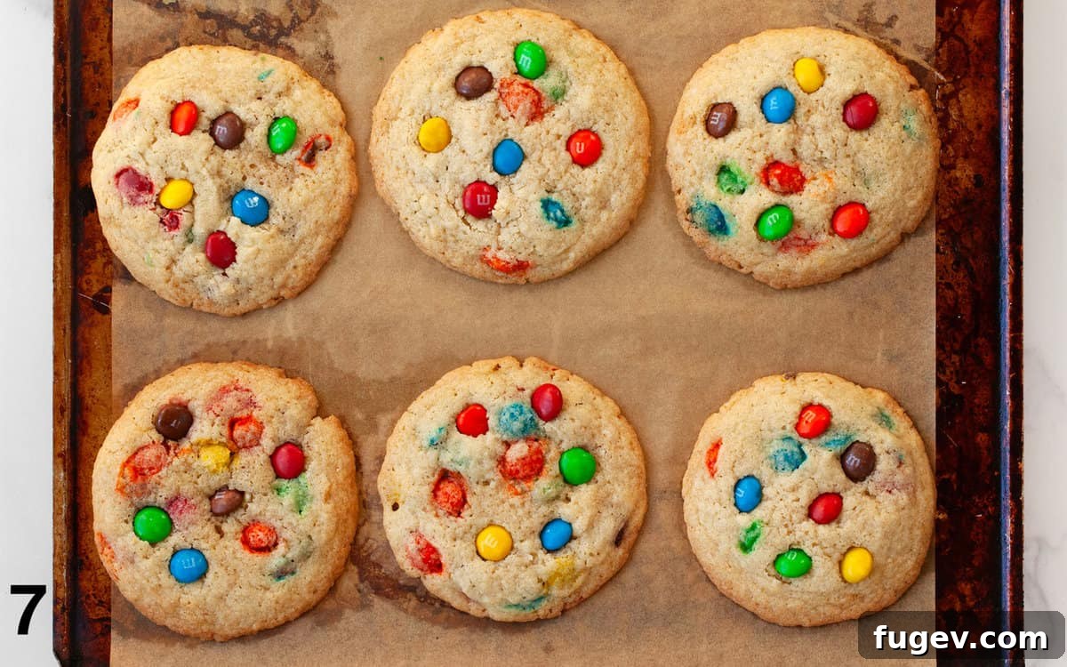 Crispy Colorful Candy Cookies 7 Freshly baked crispy M&M cookies on a baking sheet