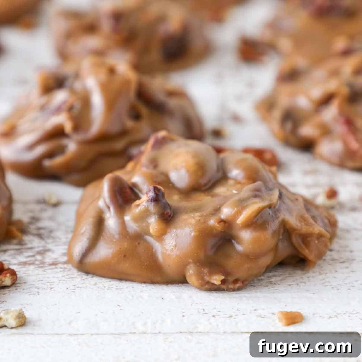 Caramel Pecan Bliss 4 glossy praline on wood board.