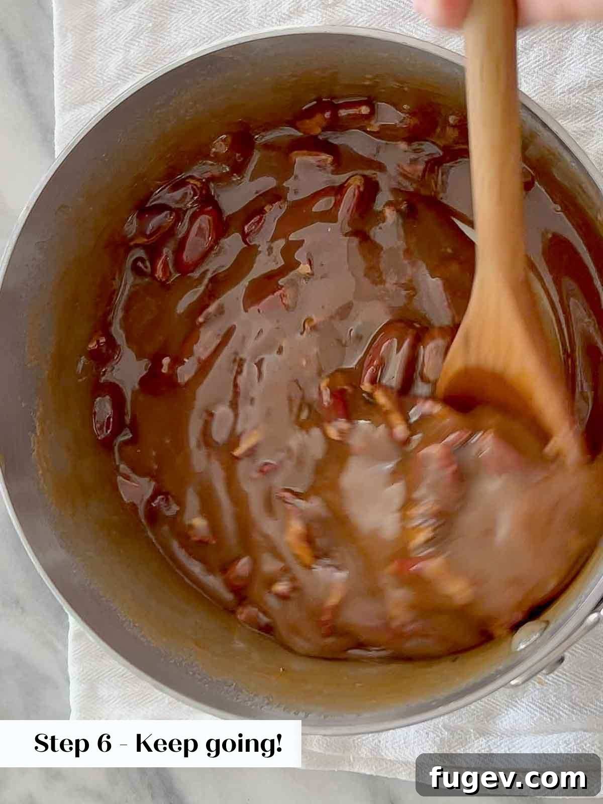 Caramel Pecan Bliss 8 stirring pecans and candy mix.