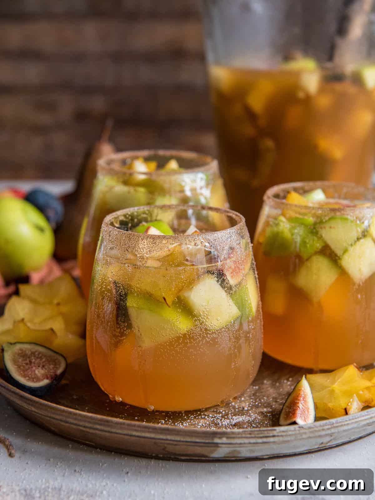 Stress-Free Thanksgiving Recipes 9 Two glasses of beautiful pear apple fig white wine sangria, garnished and ready to serve.