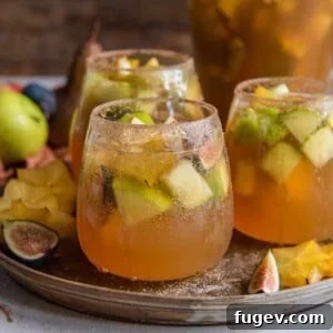 Stress-Free Thanksgiving Recipes 10 A festive white sangria, beautifully garnished with fall fruits, inviting a taste of autumn.