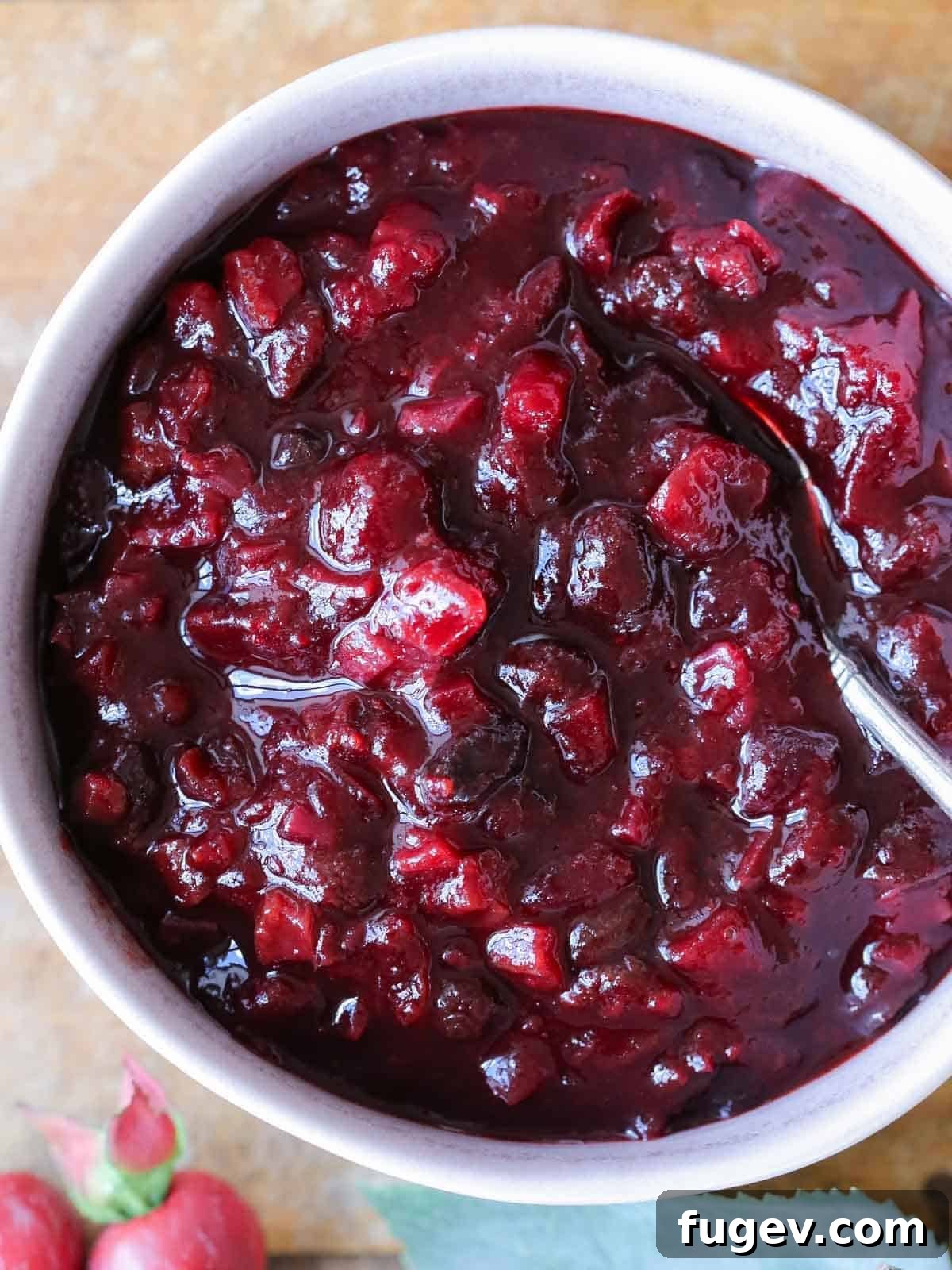 Stress-Free Thanksgiving Recipes 29 An easy Thanksgiving dinner recipe for cranberry chutney, artfully presented in a bowl on a wooden surface.