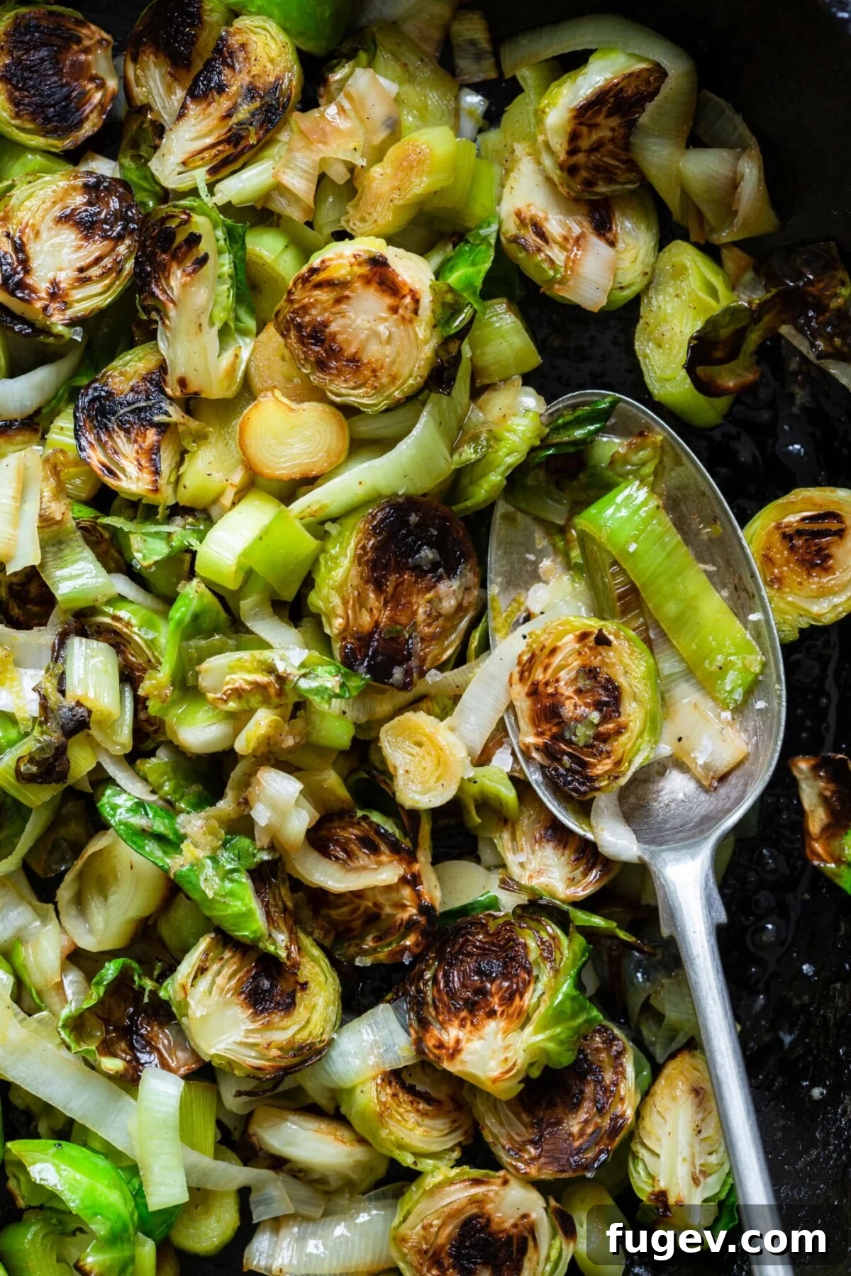 Stress-Free Thanksgiving Recipes 38 A close-up shot of Brussels Sprouts and Leeks with Lime Ginger Butter on a spoon, revealing delicious texture and flavor.