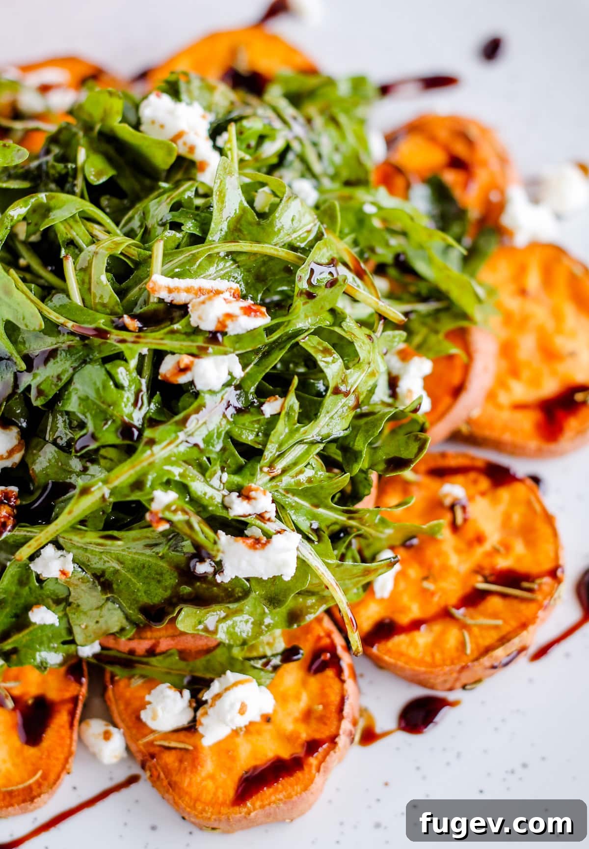 Stress-Free Thanksgiving Recipes 40 A vibrant arugula salad, adorned with roasted sweet potatoes and a delicate balsamic drizzle.