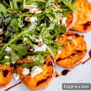 Stress-Free Thanksgiving Recipes 41 A fresh green salad with roasted sweet potatoes, elegantly arranged on a crisp white plate.