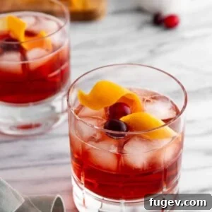 Stress-Free Thanksgiving Recipes 7 A festive Holiday Negroni cocktail sitting on a sleek marble countertop, inviting a celebratory sip.